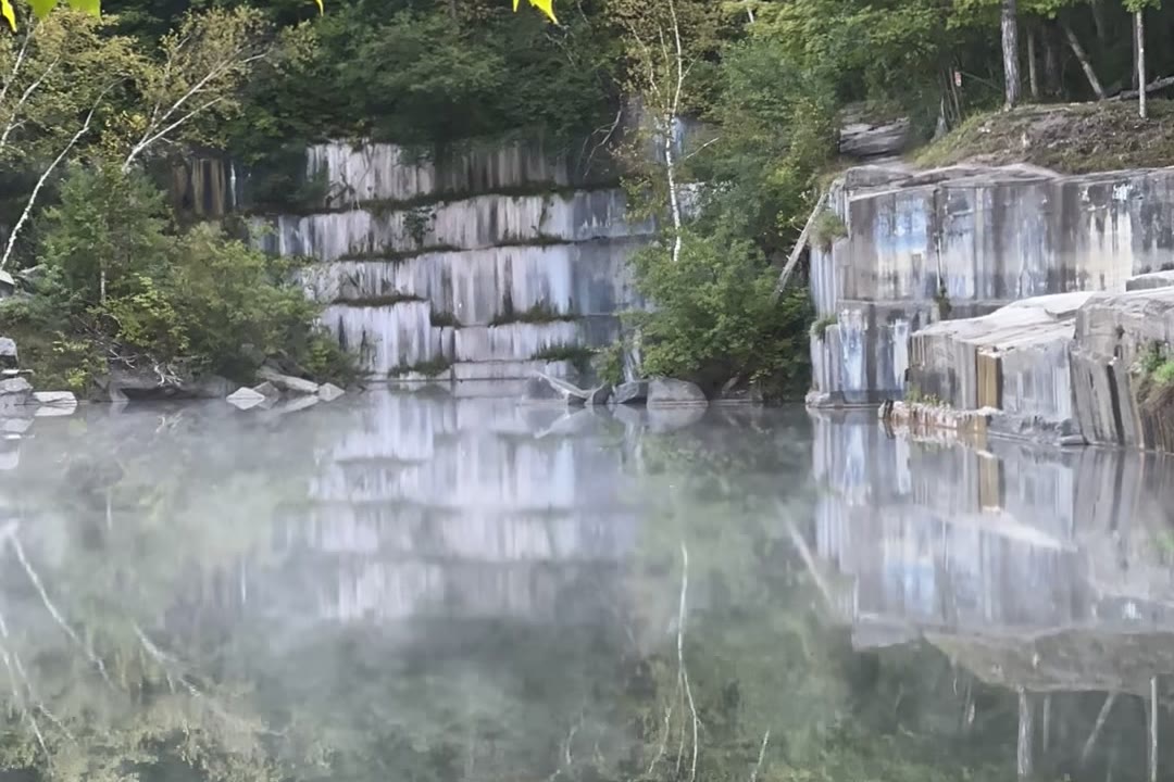 White marble ledges above morning mist on the still water of the Dorset Quarry swimming hole